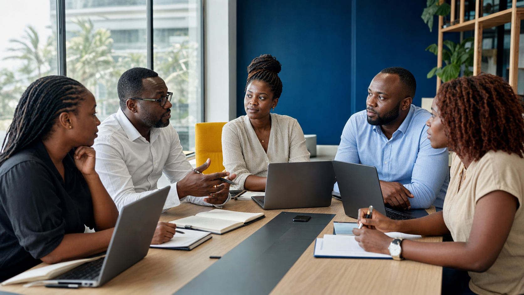A global team discussing payroll together around a table.